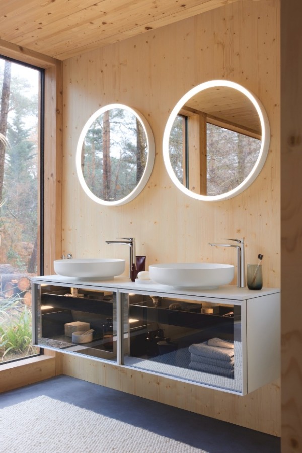 A bathroom with two round mirrors AI-generated content may be incorrect.